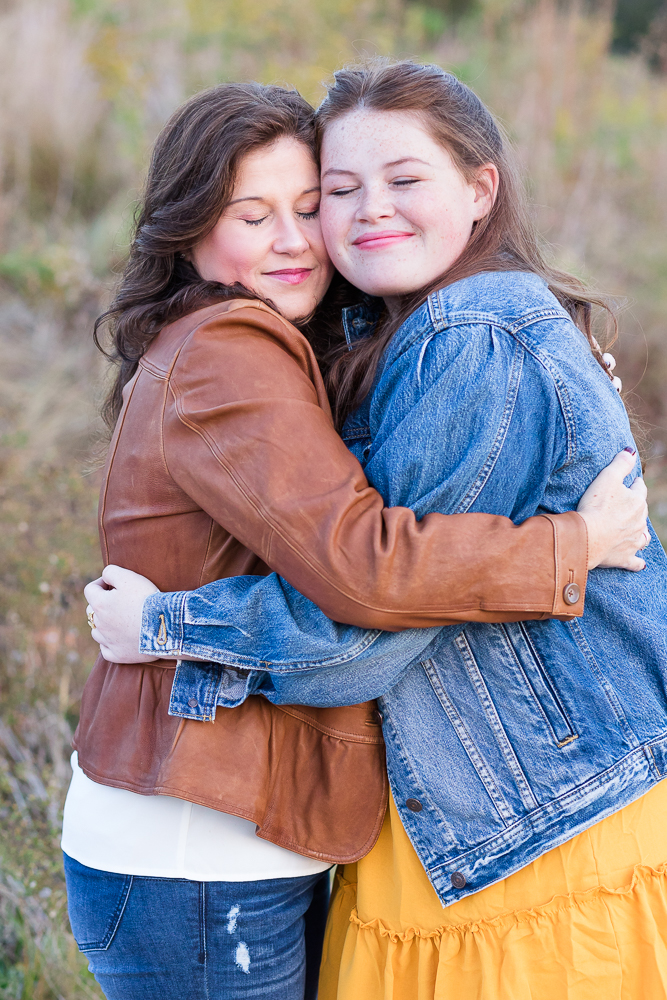 Mom and daughter hugging each other for senior portrait.